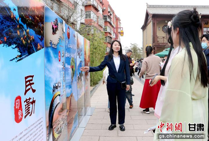 3月下旬，民勤縣在天水啟漢樓廣場(chǎng)舉行推介會(huì)，宣傳本地旅游資源和農(nóng)特優(yōu)產(chǎn)品。圖為工作人員向游客介紹民勤自然風(fēng)光、歷史文化。馬愛(ài)彬 攝