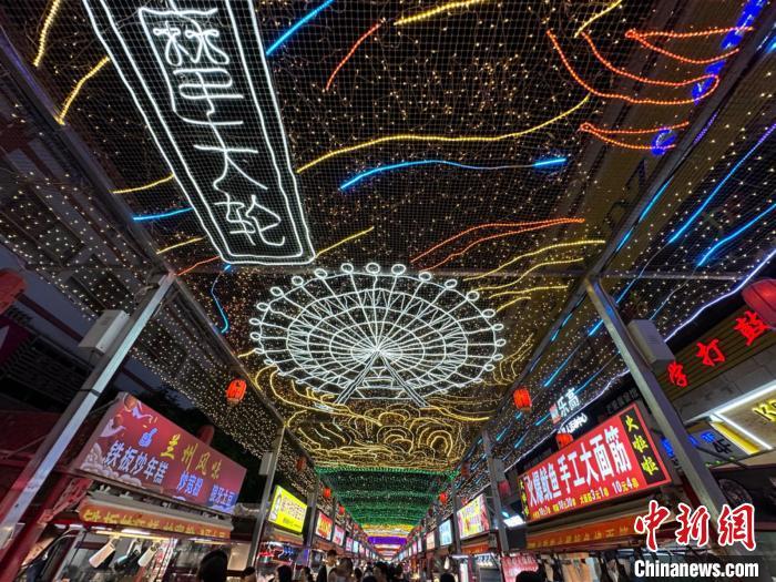 圖為明清街夜市燈光點(diǎn)亮具有武威文化元素的“摩天輪”彩燈?！〈魑牟?攝</p><p>